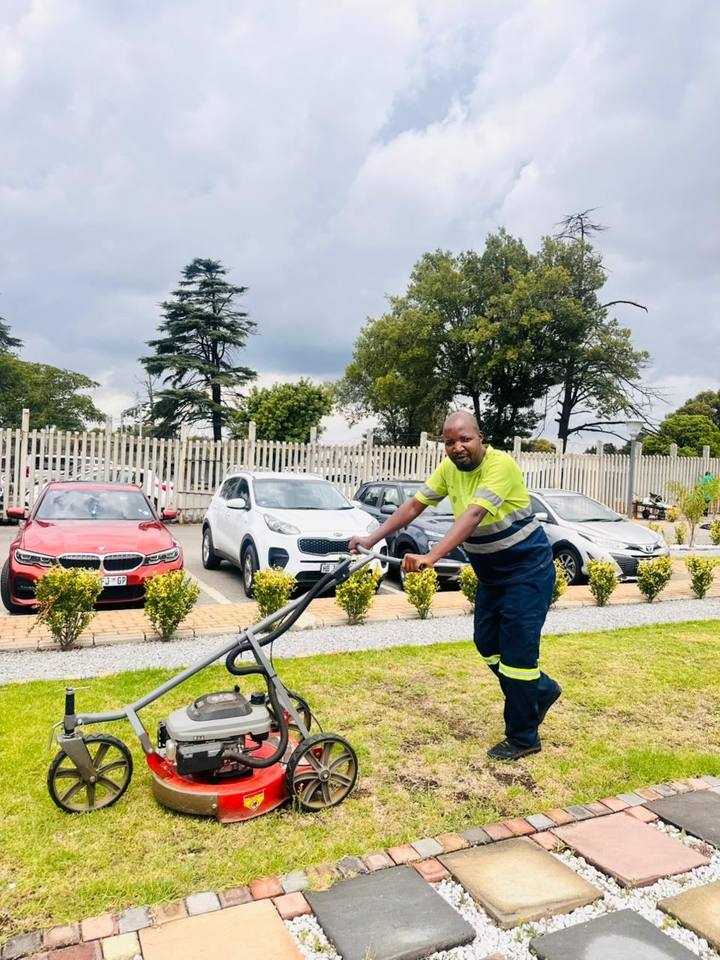 Fresh Lavation team member maintaining garden path
